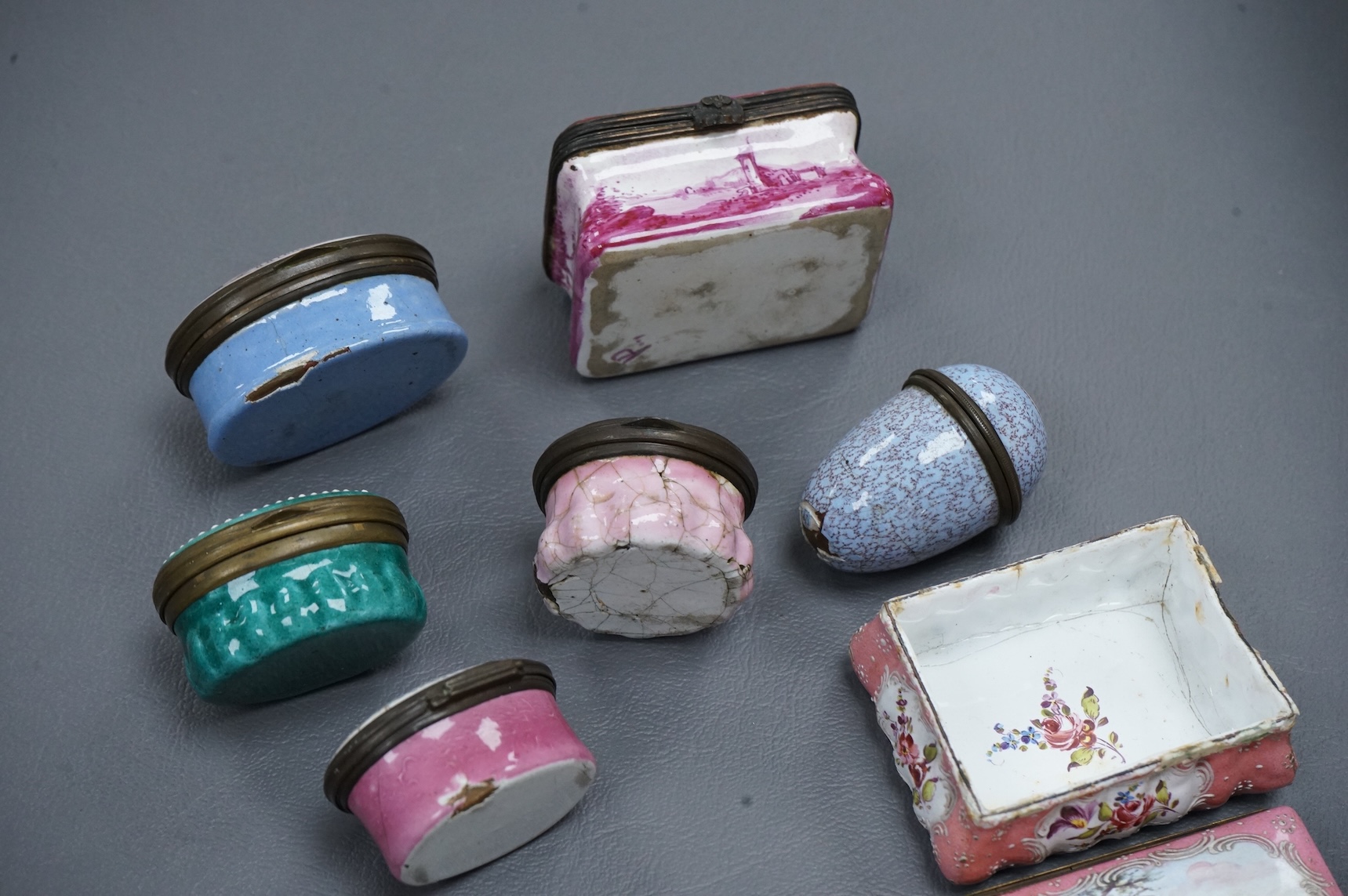 A collection of seven late 18th / early 19th century South Staffordshire enamel patch and snuff boxes and a continental porcelain snuff box, Largest 3.5cm high (8)